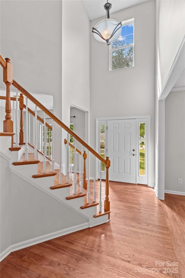 145 Summerbrook Ln, Mooresville, NC 28117 - entrance foyer featuring a towering ceiling, wood finished floors, a chandelier, and stairs