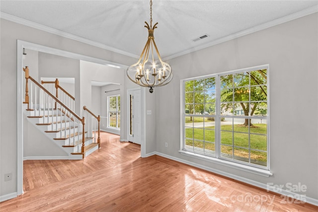 145 Summerbrook Ln, Mooresville, NC 28117 - empty room featuring wood finished floors, stairs, a chandelier, and ornamental molding