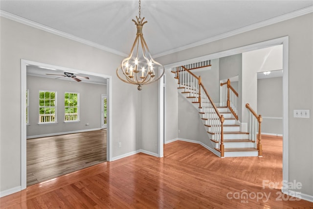 145 Summerbrook Ln, Mooresville, NC 28117 - unfurnished room with wood finished floors, stairs, ornamental molding, a chandelier, and a ceiling fan