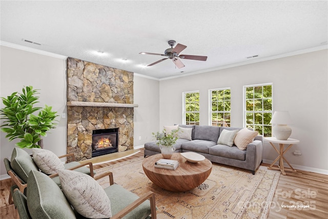 145 Summerbrook Ln, Mooresville, NC 28117 - living area with light wood-style floors, a ceiling fan, crown molding, and a stone fireplace