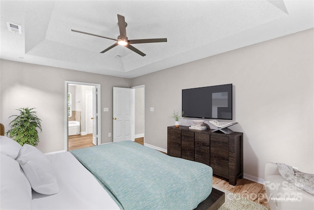 145 Summerbrook Ln, Mooresville, NC 28117 - bedroom with light wood-type flooring, a raised ceiling, a ceiling fan, and ensuite bathroom