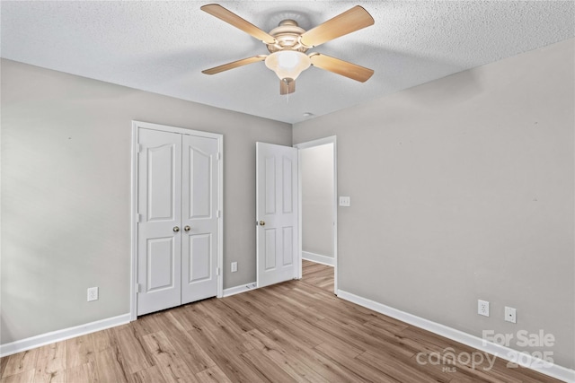 145 Summerbrook Ln, Mooresville, NC 28117 - unfurnished bedroom with wood finished floors, a closet, ceiling fan, and a textured ceiling