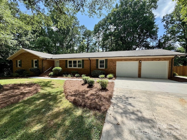 635 Windsor Pl NE, Concord, NC 28025 - ranch-style home with concrete driveway, a garage, and brick siding