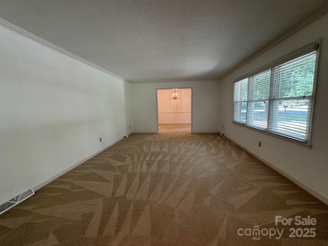 635 Windsor Pl NE, Concord, NC 28025 - spare room featuring light carpet, a textured ceiling, a chandelier, and crown molding