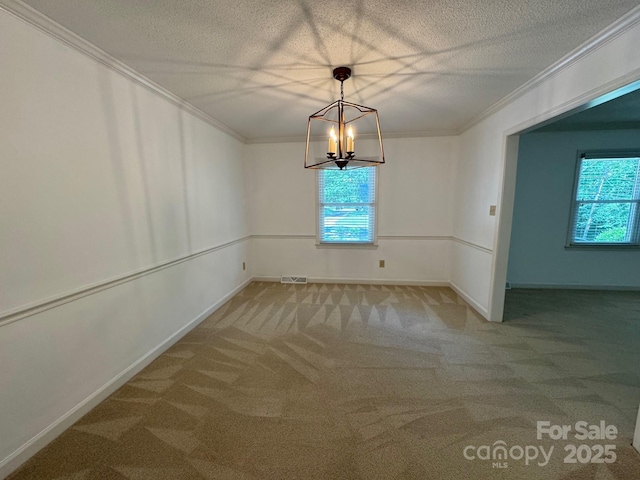 635 Windsor Pl NE, Concord, NC 28025 - unfurnished room featuring ornamental molding, carpet flooring, a chandelier, and a textured ceiling