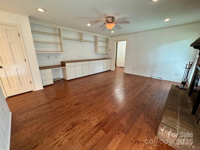 635 Windsor Pl NE, Concord, NC 28025 - unfurnished living room featuring ceiling fan, dark wood-style flooring, ornamental molding, recessed lighting, and an office area