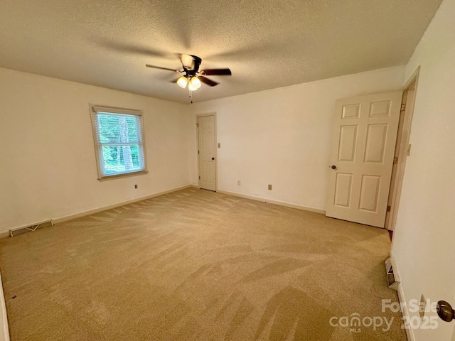 635 Windsor Pl NE, Concord, NC 28025 - unfurnished room featuring light carpet, ceiling fan, and a textured ceiling