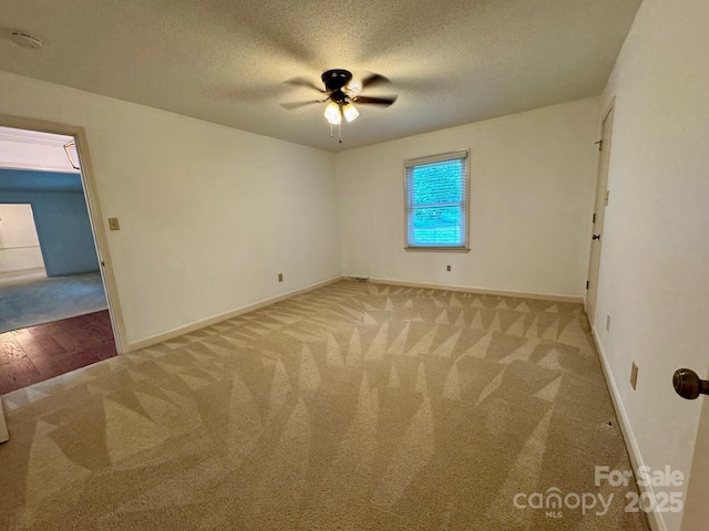 635 Windsor Pl NE, Concord, NC 28025 - spare room with carpet, a textured ceiling, ceiling fan, and a smoke detector