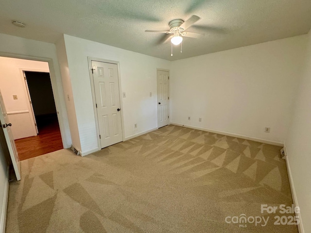 635 Windsor Pl NE, Concord, NC 28025 - unfurnished bedroom with light colored carpet, a textured ceiling, and ceiling fan
