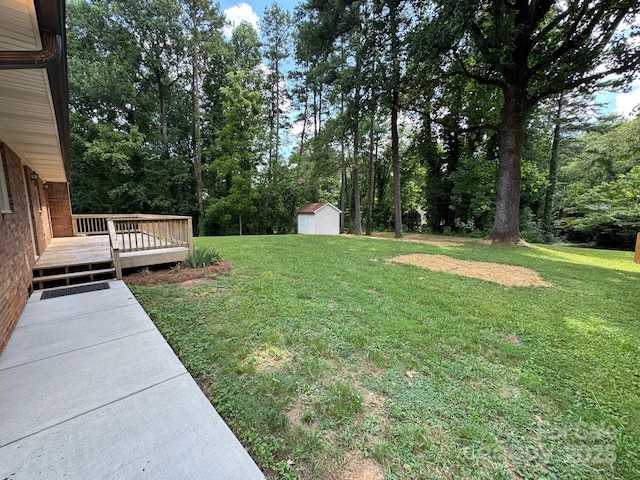 635 Windsor Pl NE, Concord, NC 28025 - view of grassy yard with a deck and a storage unit