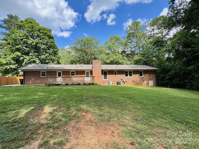 635 Windsor Pl NE, Concord, NC 28025 - back of house featuring brick siding, a deck, and a chimney