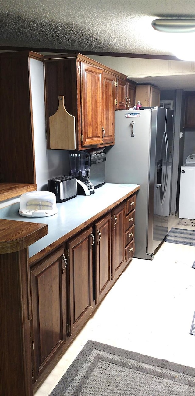 101 Branch Breeze Ln, Zirconia, NC 28790 - kitchen featuring washer / dryer, stainless steel fridge, light countertops, and a textured ceiling