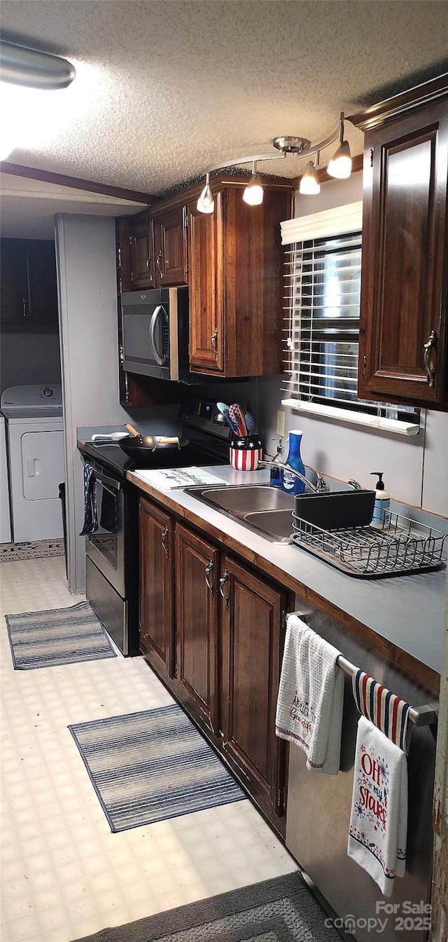 101 Branch Breeze Ln, Zirconia, NC 28790 - kitchen featuring electric stove, separate washer and dryer, dark brown cabinets, light countertops, and a textured ceiling