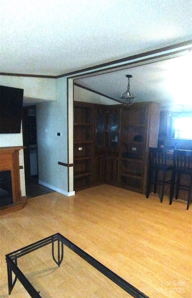 101 Branch Breeze Ln, Zirconia, NC 28790 - living room with wood finished floors, a fireplace with raised hearth, a textured ceiling, and built in features