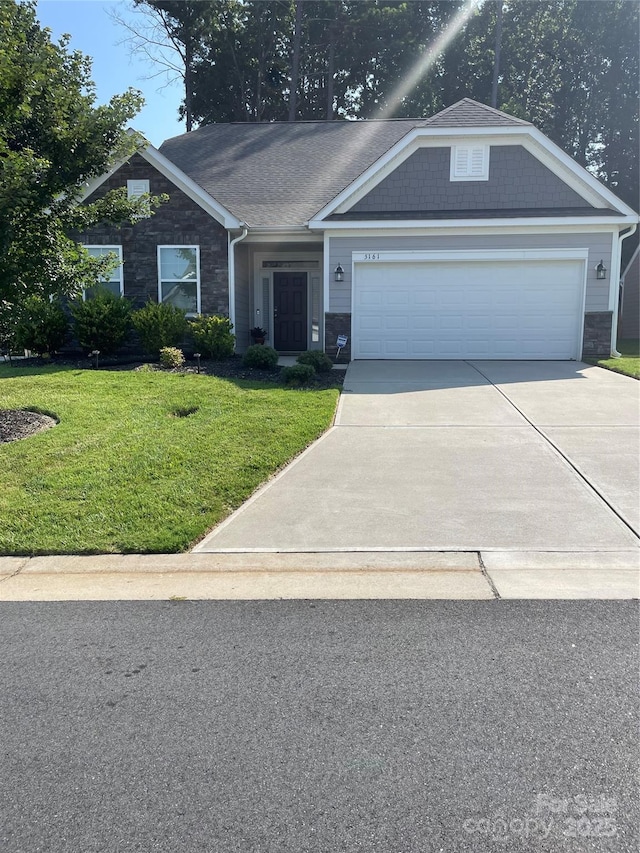 5161 Quail Forest Dr, Clemmons, NC 27012 - view of front facade with stone siding, driveway, a front yard, and an attached garage