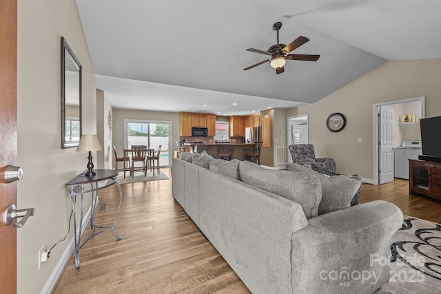 1974 Redwood Dr, Oakboro, NC 28129 - living area with lofted ceiling, independent washer and dryer, ceiling fan, light wood-style flooring, and recessed lighting