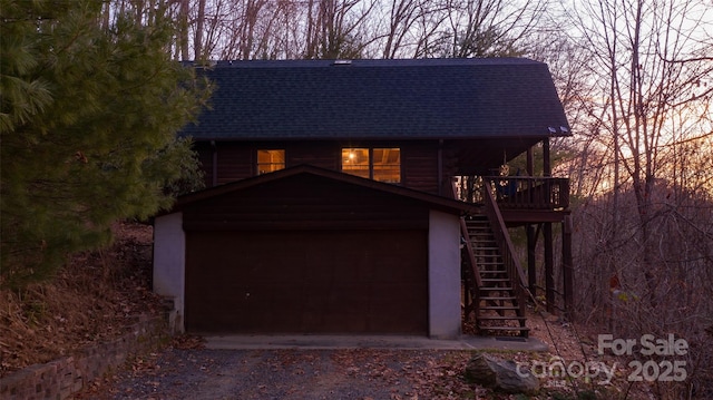 2311 Old Mountain Rd, Mars Hill, NC 28754 - view of front of house with roof with shingles, stairs, driveway, a garage, and stucco siding