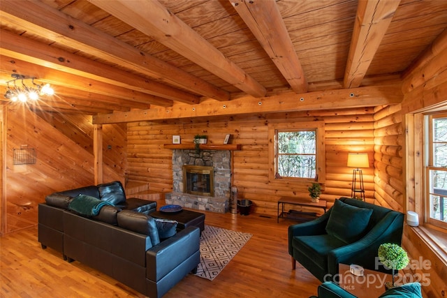 2311 Old Mountain Rd, Mars Hill, NC 28754 - living area featuring a wooden ceiling with exposed beams, wood finished floors, and a stone fireplace