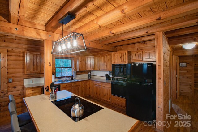 2311 Old Mountain Rd, Mars Hill, NC 28754 - kitchen with black appliances, dark wood-style flooring, a wooden ceiling with exposed beams, decorative light fixtures, and wooden walls