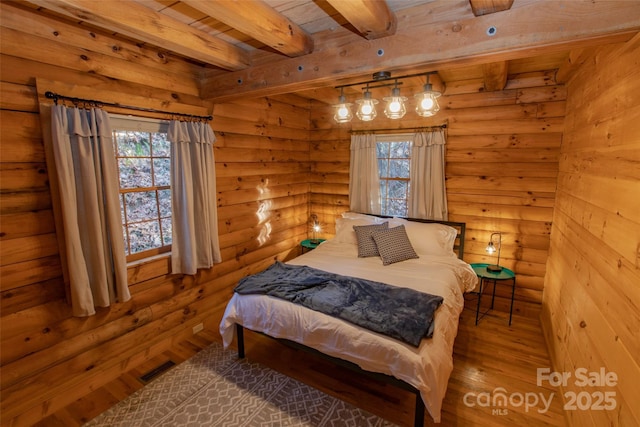 2311 Old Mountain Rd, Mars Hill, NC 28754 - bedroom with wood finished floors, multiple windows, rustic walls, and a wooden ceiling with exposed beams