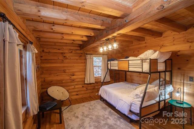 2311 Old Mountain Rd, Mars Hill, NC 28754 - bedroom featuring a wooden ceiling with exposed beams, wood finished floors, and log walls
