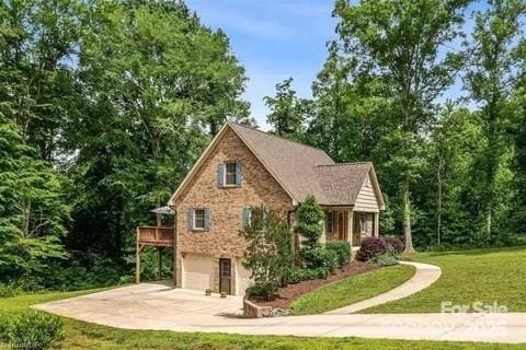 845 Montgomery Ct, Walnut Cove, NC 27052 - view of property exterior featuring a garage, concrete driveway, and a lawn