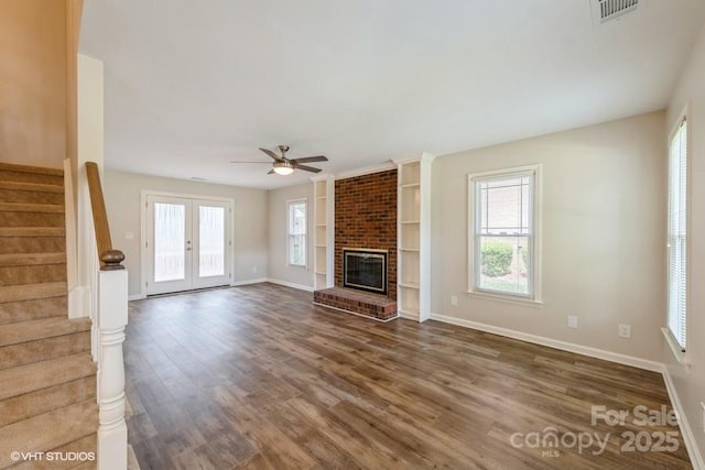 608 Laurel Fork Dr, Matthews, NC 28105 - unfurnished living room with stairs, wood finished floors, ceiling fan, and plenty of natural light
