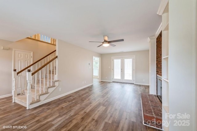 608 Laurel Fork Dr, Matthews, NC 28105 - unfurnished living room with a ceiling fan, a fireplace, stairs, and wood finished floors