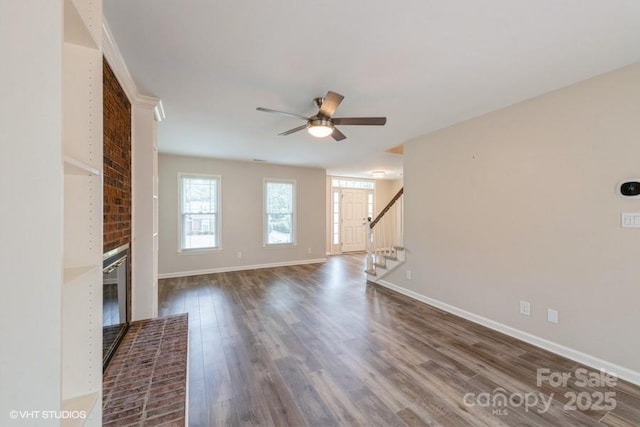 608 Laurel Fork Dr, Matthews, NC 28105 - unfurnished living room with ceiling fan, stairs, dark wood-style floors, and a fireplace