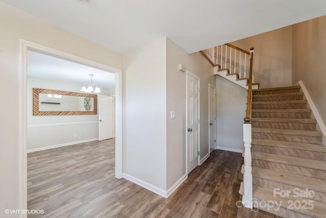 608 Laurel Fork Dr, Matthews, NC 28105 - stairway featuring wood finished floors and a chandelier