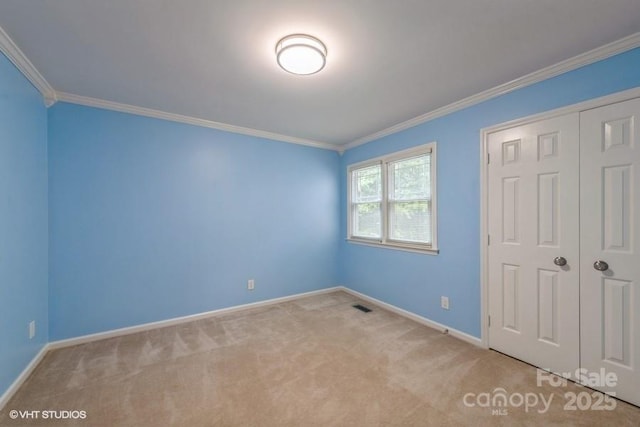 608 Laurel Fork Dr, Matthews, NC 28105 - unfurnished bedroom featuring carpet flooring, crown molding, and a closet