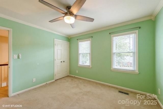608 Laurel Fork Dr, Matthews, NC 28105 - unfurnished bedroom with multiple windows, ornamental molding, light carpet, a closet, and a ceiling fan