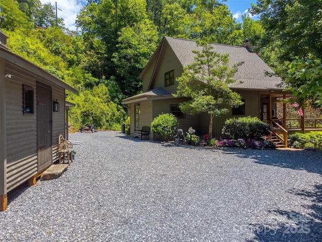 846 Duckback Trl, Whittier, NC 28789 - view of side of home with roof with shingles, covered porch, and a chimney