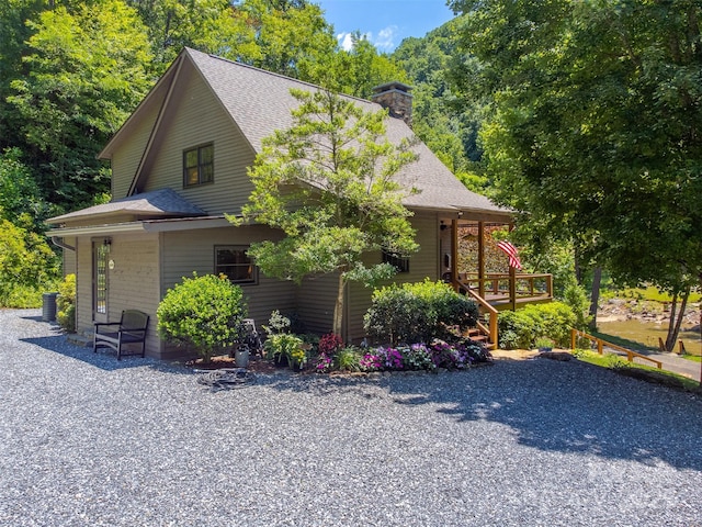 846 Duckback Trl, Whittier, NC 28789 - view of front of home with a shingled roof, covered porch, and a chimney