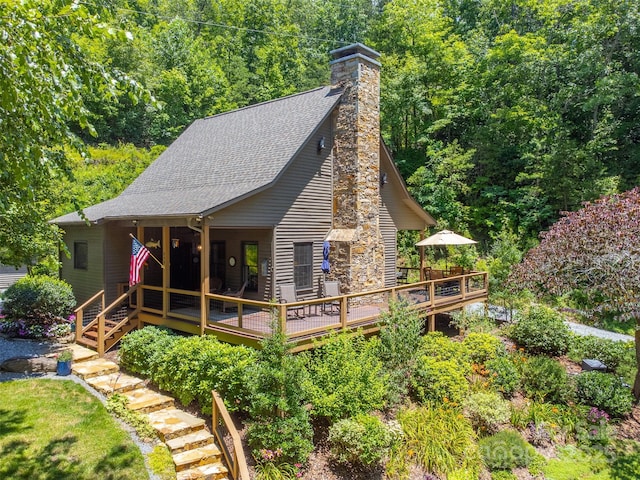 846 Duckback Trl, Whittier, NC 28789 - view of front of home featuring roof with shingles, a chimney, and a wooden deck