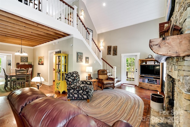 846 Duckback Trl, Whittier, NC 28789 - living room featuring hardwood / wood-style floors, healthy amount of natural light, high vaulted ceiling, a chandelier, and stairs