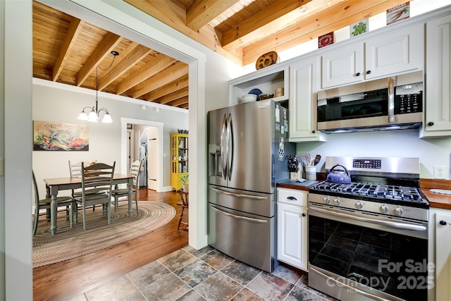 846 Duckback Trl, Whittier, NC 28789 - kitchen with appliances with stainless steel finishes, a chandelier, a wooden ceiling with exposed beams, white cabinetry, and butcher block counters