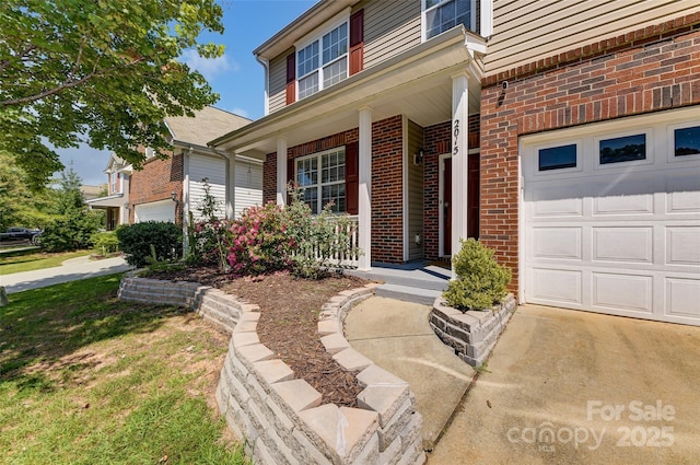 2015 Savannah Hills Dr, Matthews, NC 28105 - property entrance with a garage, covered porch, and brick siding