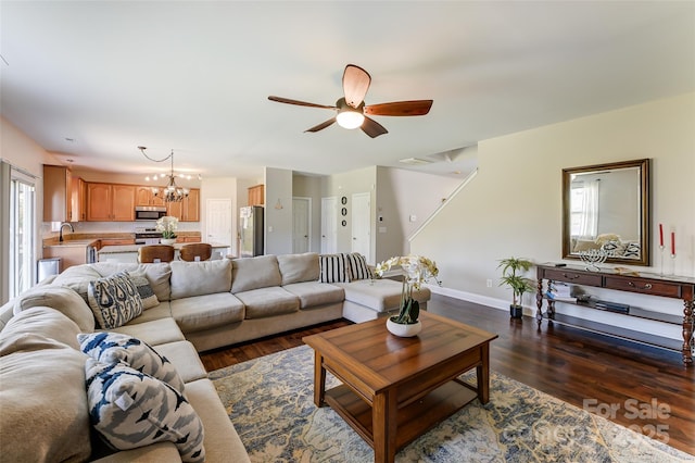 2015 Savannah Hills Dr, Matthews, NC 28105 - living room with dark wood finished floors, a chandelier, and a ceiling fan