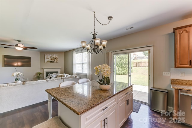 2015 Savannah Hills Dr, Matthews, NC 28105 - kitchen with dark wood-style floors, open floor plan, a chandelier, a kitchen island, and light stone counters
