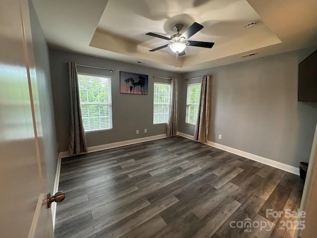 9711 Marquette St NW, Concord, NC 28027 - empty room featuring a raised ceiling, a ceiling fan, and dark wood-style flooring