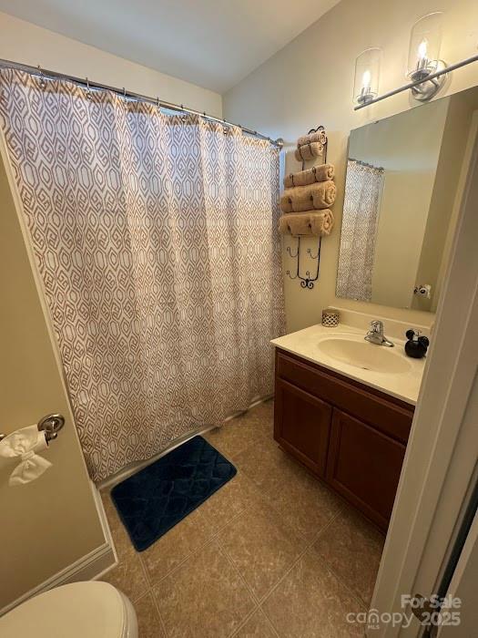 9711 Marquette St NW, Concord, NC 28027 - full bathroom featuring vanity, tile patterned flooring, and a shower with shower curtain