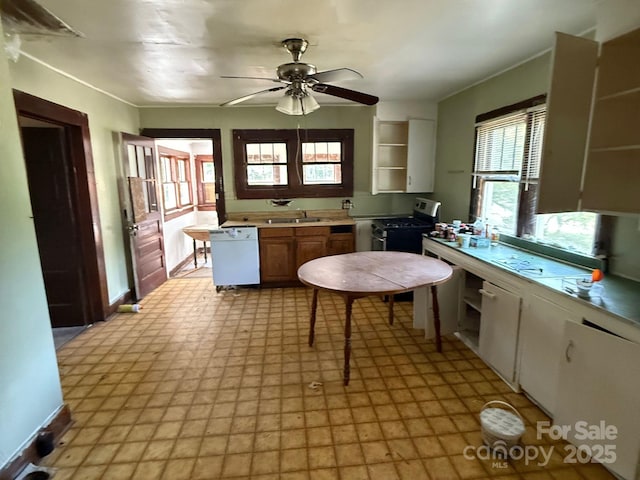 410 24th St SW, Hickory, NC 28602 - kitchen featuring white dishwasher, gas stove, open shelves, a ceiling fan, and light floors