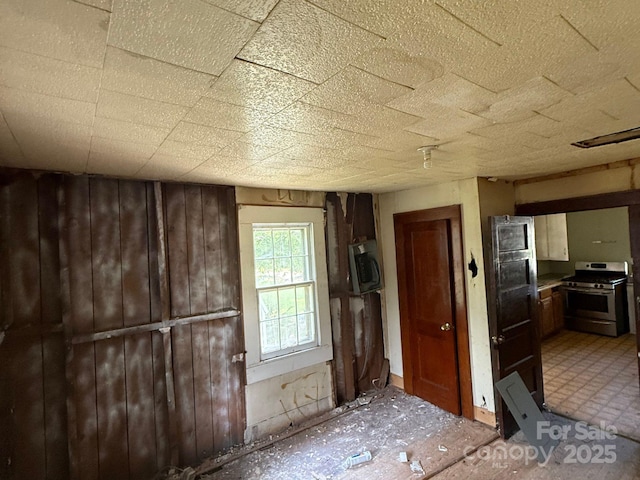 410 24th St SW, Hickory, NC 28602 - kitchen featuring stainless steel range with gas cooktop and wooden walls