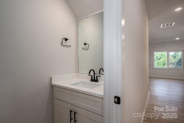 837 32nd St NE, Conover, NC 28613 - bathroom featuring vanity, wood finished floors, and recessed lighting