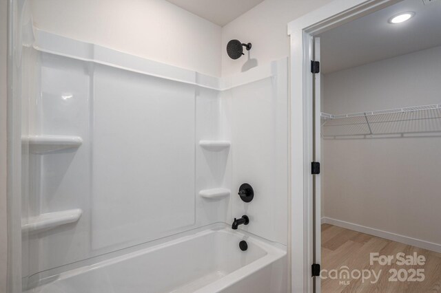837 32nd St NE, Conover, NC 28613 - bathroom featuring shower / washtub combination, wood finished floors, a walk in closet, and recessed lighting