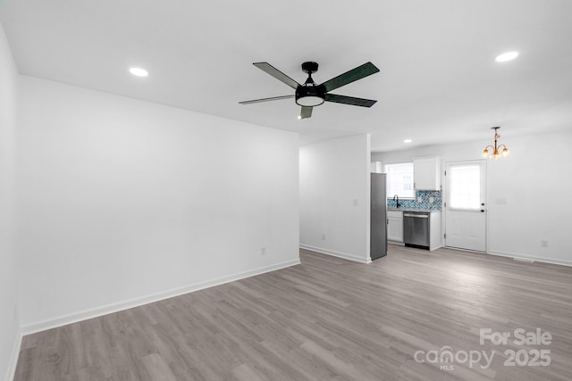 801 Evening Shade Ln, Gastonia, NC 28052 - unfurnished living room with a chandelier, light wood-style floors, recessed lighting, and a ceiling fan
