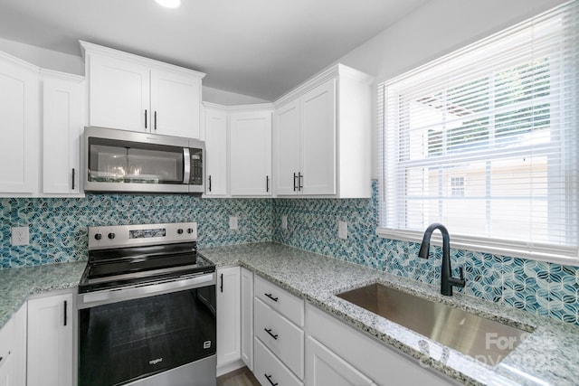 801 Evening Shade Ln, Gastonia, NC 28052 - kitchen featuring stainless steel appliances, white cabinetry, backsplash, and light stone countertops