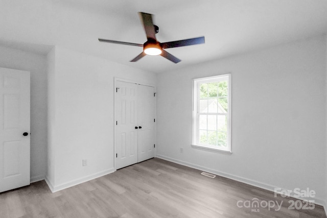 801 Evening Shade Ln, Gastonia, NC 28052 - unfurnished bedroom with light wood-style floors, a closet, and a ceiling fan