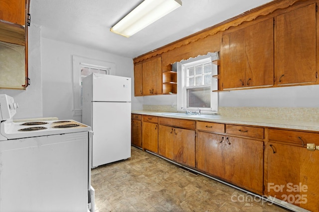 117 3rd Ave SW, Hickory, NC 28602 - kitchen with white appliances, light countertops, brown cabinetry, and open shelves